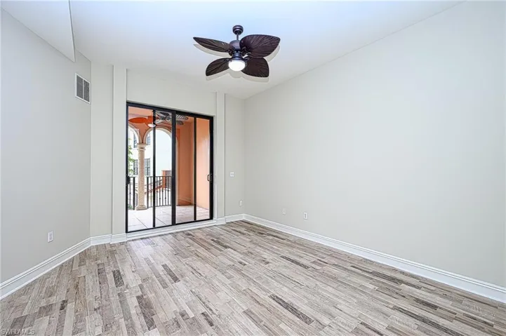 Unfurnished room featuring ceiling fan and light wood-type flooring