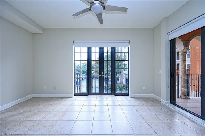 Spare room featuring ceiling fan, french doors, and light tile patterned floors