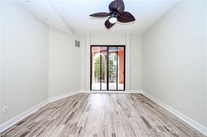 Empty room with light wood-type flooring and ceiling fan