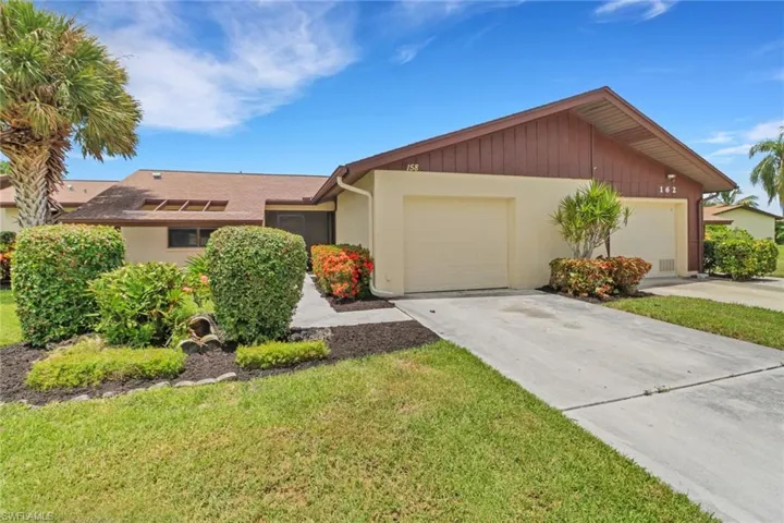 Ranch-style home with a garage and a front yard