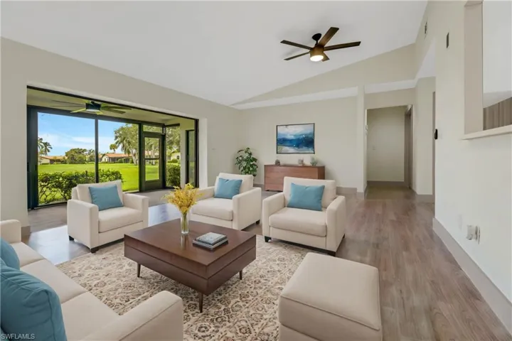 Living room featuring lofted ceiling, light hardwood / wood-style flooring, and ceiling fan
