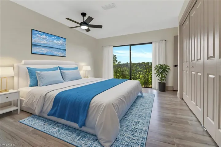 Bedroom featuring light hardwood / wood-style flooring, a closet, and ceiling fan
