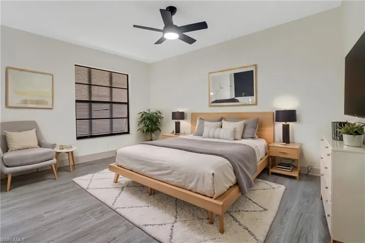 Bedroom featuring ceiling fan and hardwood / wood-style flooring