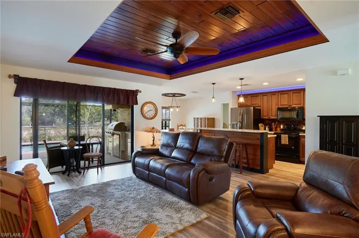 Living area with tongue-and-groove tray ceiling with ambient lighting
