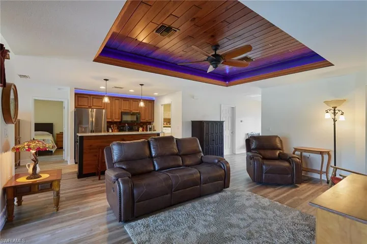 Living area with tongue-and-groove tray ceiling with ambient lighting