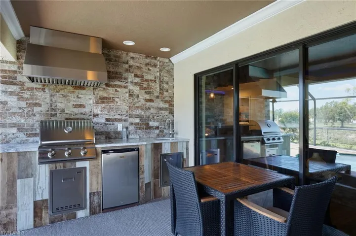 View of patio / terrace featuring area for grilling, grilling area, a sink, and outdoor dining area