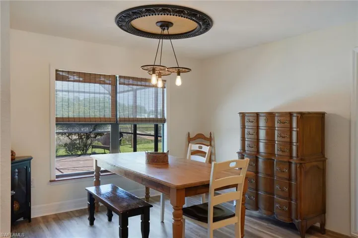 Dining space chandelier, looking out on pool deck
