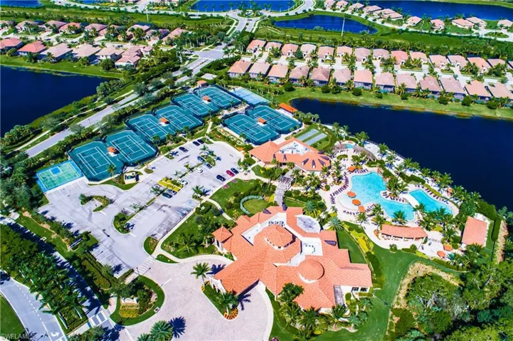 Expansive clubhouse featuring a large swimming pool with integrated spa and multiple tennis courts