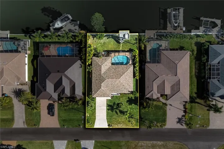 Aerial overview of property's location with property boundaries highlighted and a large body of water