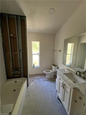 Bathroom featuring a tub and vanity