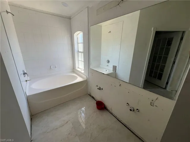 Full bath with a garden tub and vanity