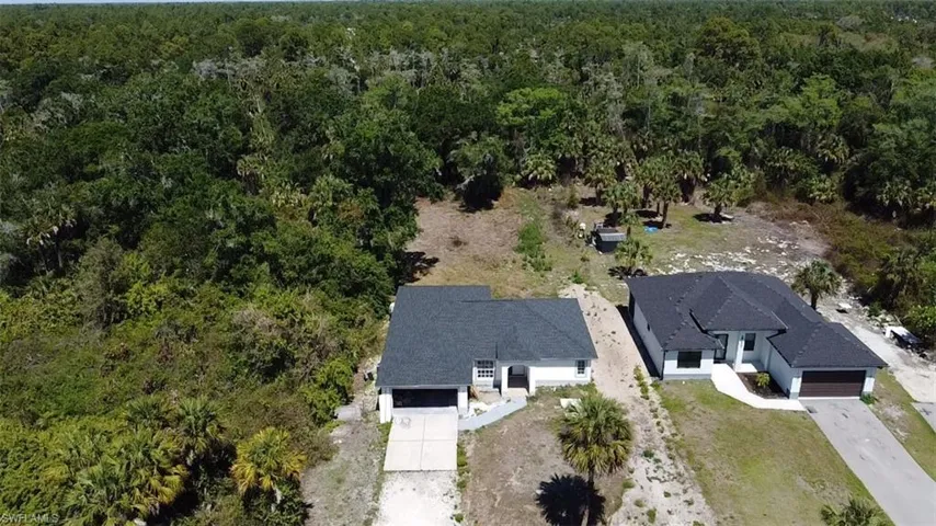 View of subject property featuring a heavily wooded area