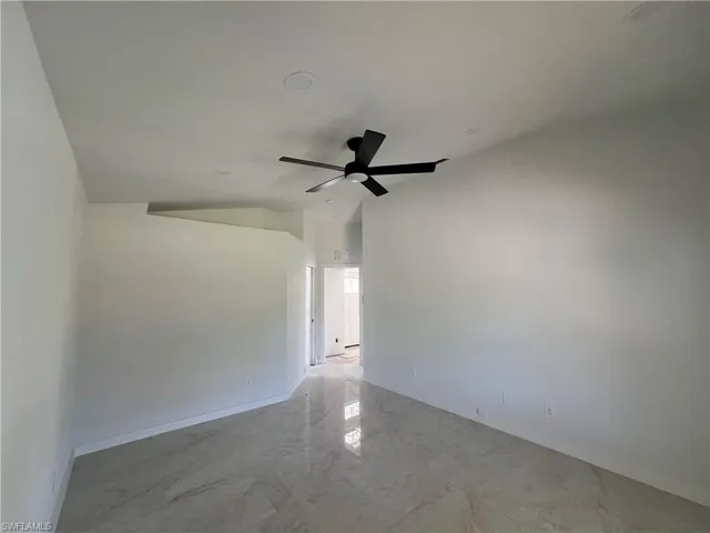 Empty room with light marble finish flooring and ceiling fan