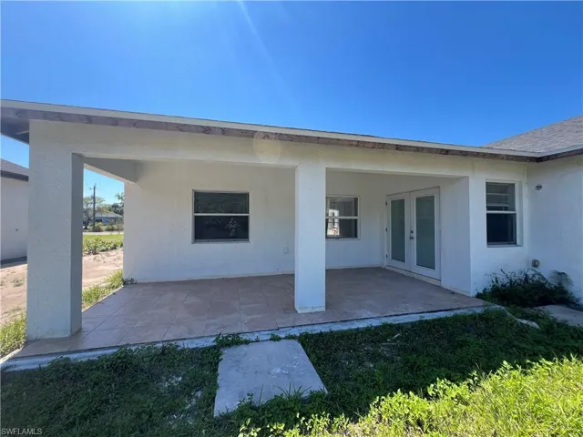 Back of house featuring a patio, stucco siding, and french doors