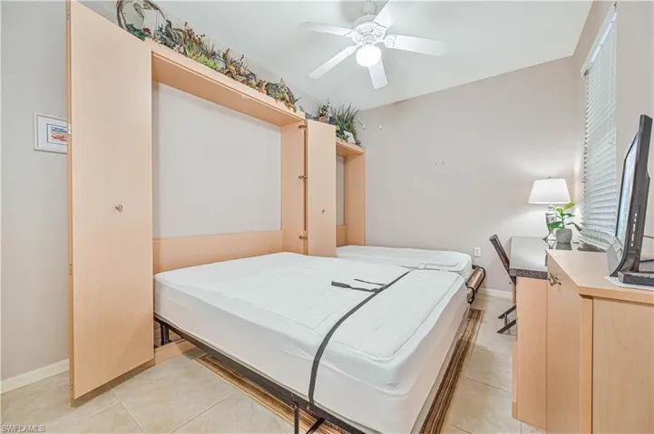 Bedroom featuring light tile patterned floors and ceiling fan