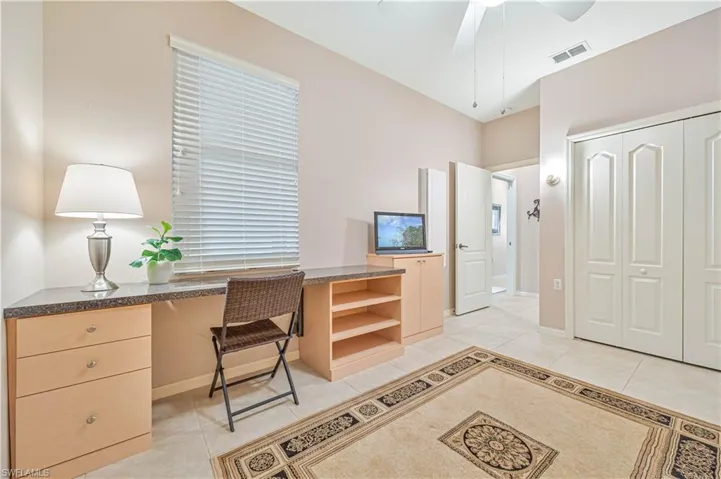 Office with ceiling fan and light tile patterned floors