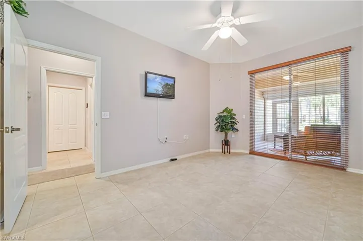 Unfurnished room with light tile patterned flooring and ceiling fan