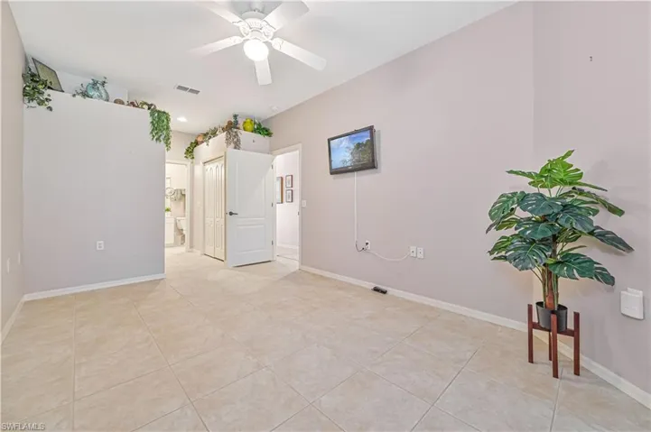 Spare room featuring light tile patterned flooring and ceiling fan