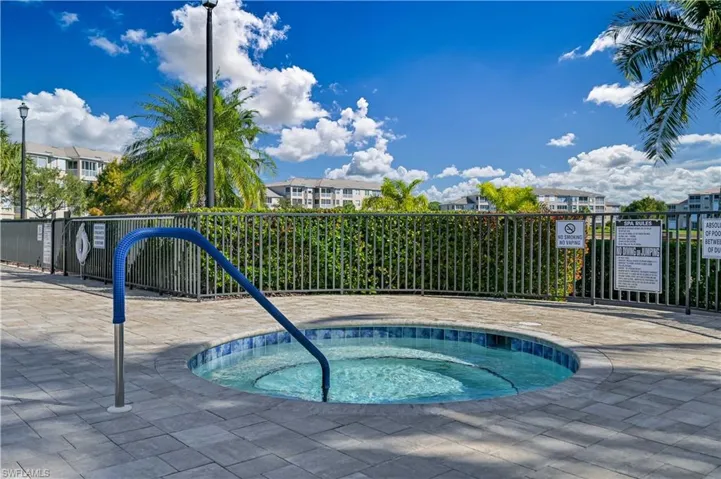 View of pool with a hot tub