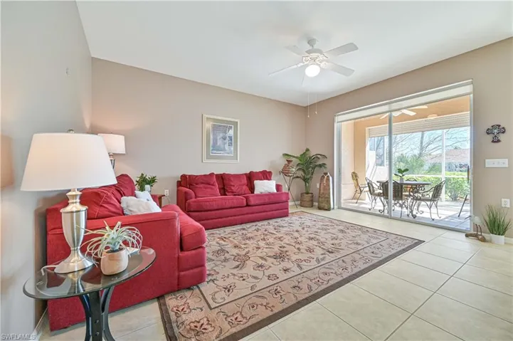 Tiled living room featuring ceiling fan