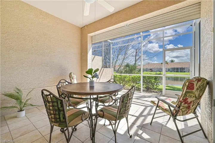 Sunroom with a water view and ceiling fan