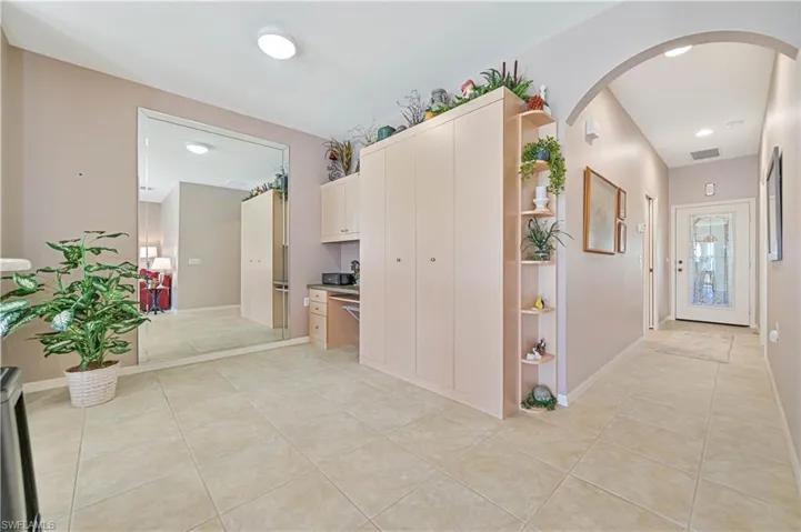 Hallway with light tile patterned floors