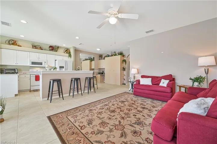 Tiled living room featuring ceiling fan