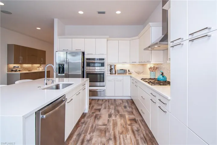 GE stainless appliances: dishwasher, refrigerator, microwave, oven and warming drawer.