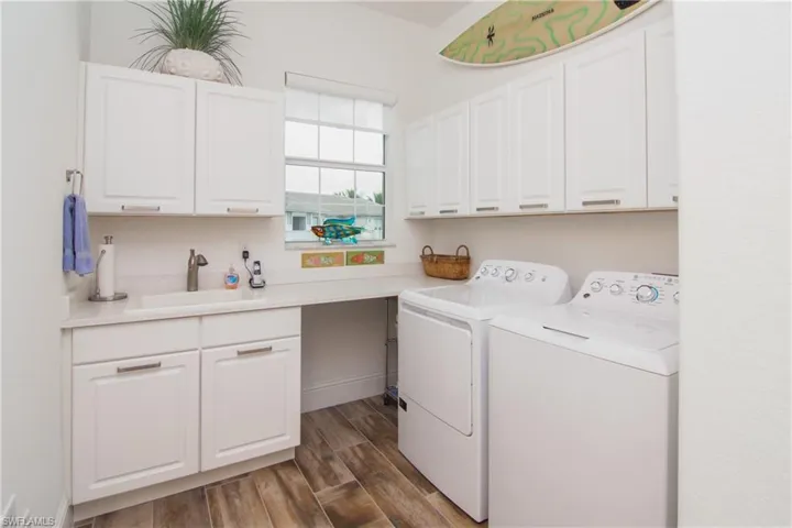 Spacious utility room.  Laundry, sink, HVAC and hot water heater.  Level III Nordic white thermafoil cabinets.