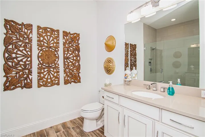 Bedroom 2 ensuite bath with walk-in shower and quartz countertop.
