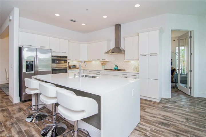 Natural gas cooktop, GE refrigerator, microwave, oven and warming tray.
