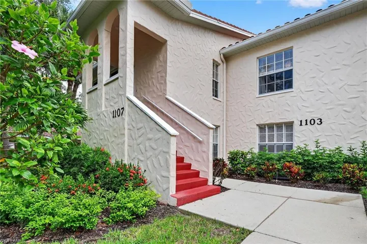 Entrance to property with stucco siding and a patio