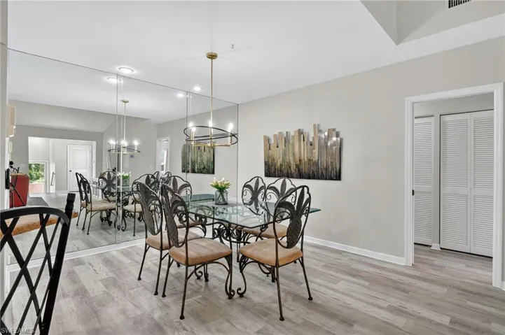 Dining space featuring light wood-type flooring, a chandelier, and recessed lighting