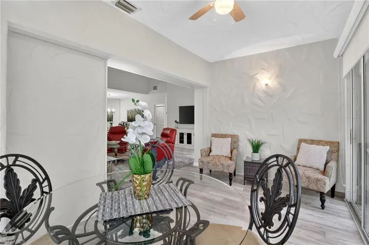 Living area with a ceiling fan and light wood-style floors