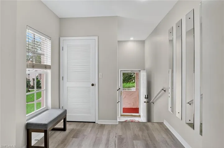 Foyer featuring wood finished floors and healthy amount of natural light