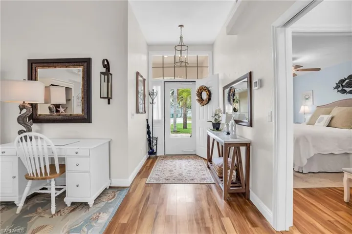Foyer entrance with ceiling fan and hardwood / wood-style floors