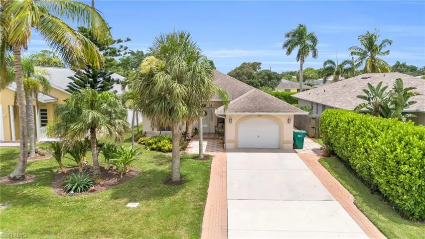 View of front of property with a garage and a front yard