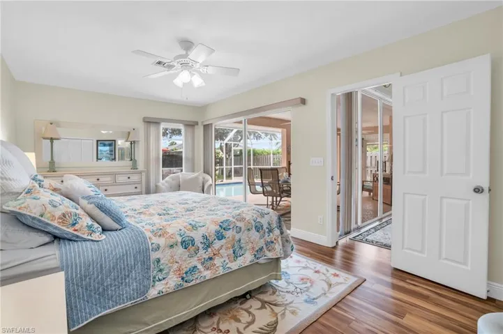 Bedroom with access to outside, dark hardwood / wood-style flooring, and ceiling fan