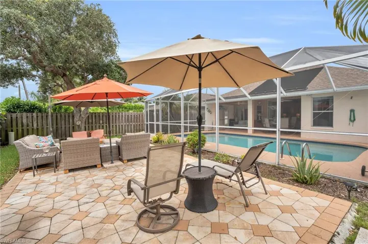 View of swimming pool with a patio area, glass enclosure, and outdoor lounge area