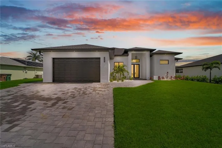 Prairie-style house with a garage and a yard
