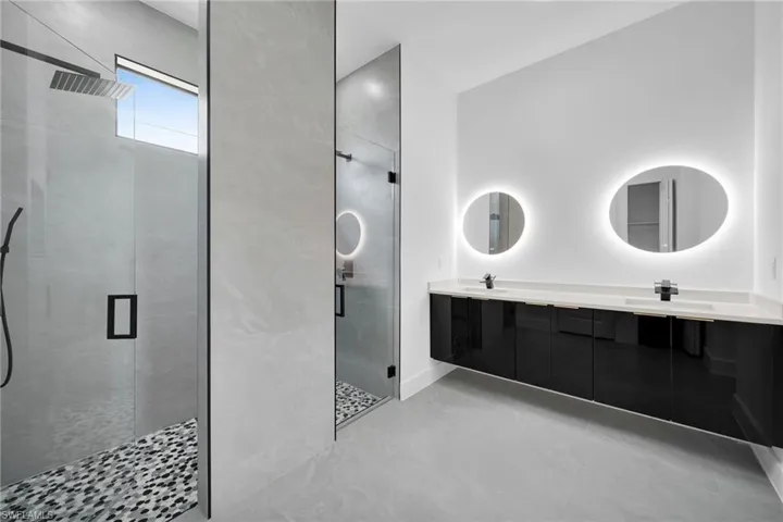 Bathroom featuring double vanity and walk in shower