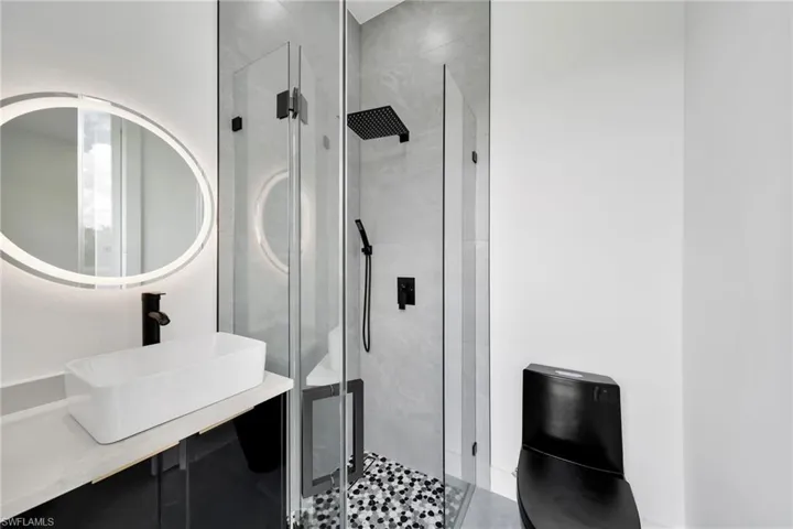Bathroom with vanity and a shower with door
