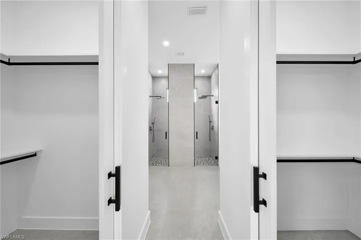 Spacious closet with light tile patterned floors
