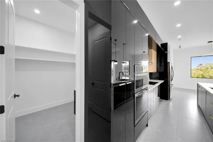 Kitchen featuring hanging light fixtures, sink, and light tile patterned flooring