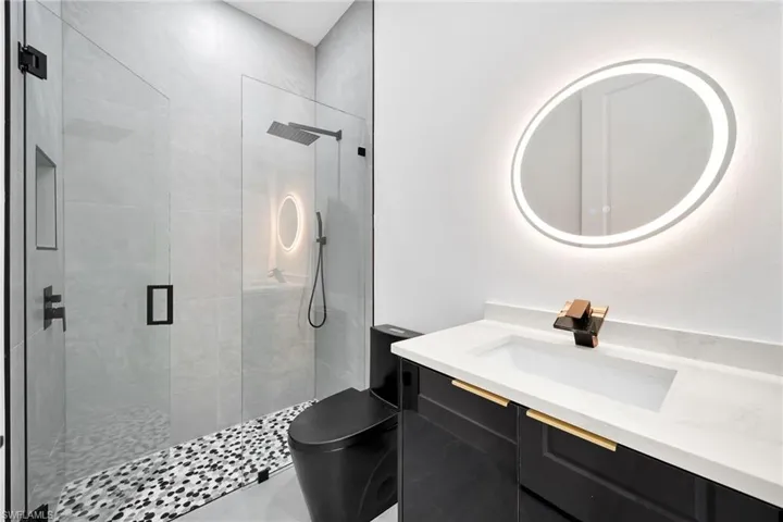 Bathroom with vanity and a tile shower