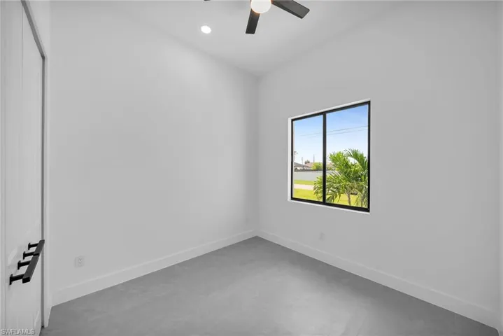 Spare room featuring concrete floors and ceiling fan