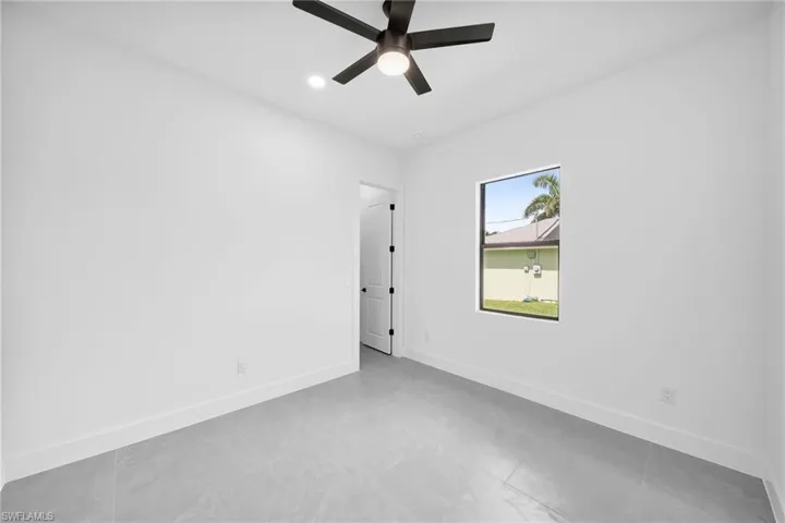Spare room featuring tile patterned floors and ceiling fan