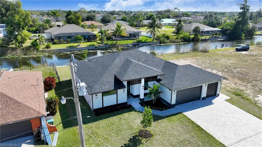 Aerial perspective of suburban area featuring a nearby body of water