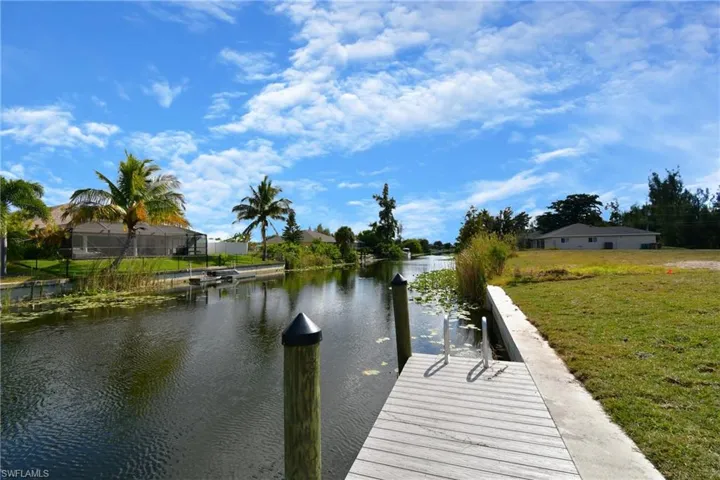 Dock featuring a water view and a yard
