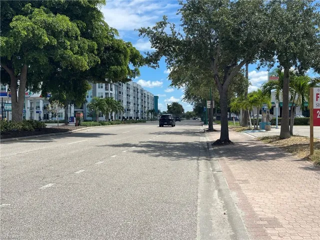 View of asphalt road with curbs and sidewalks